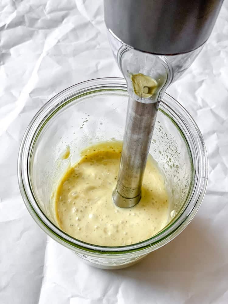 process shot showing using immersion blender in jar