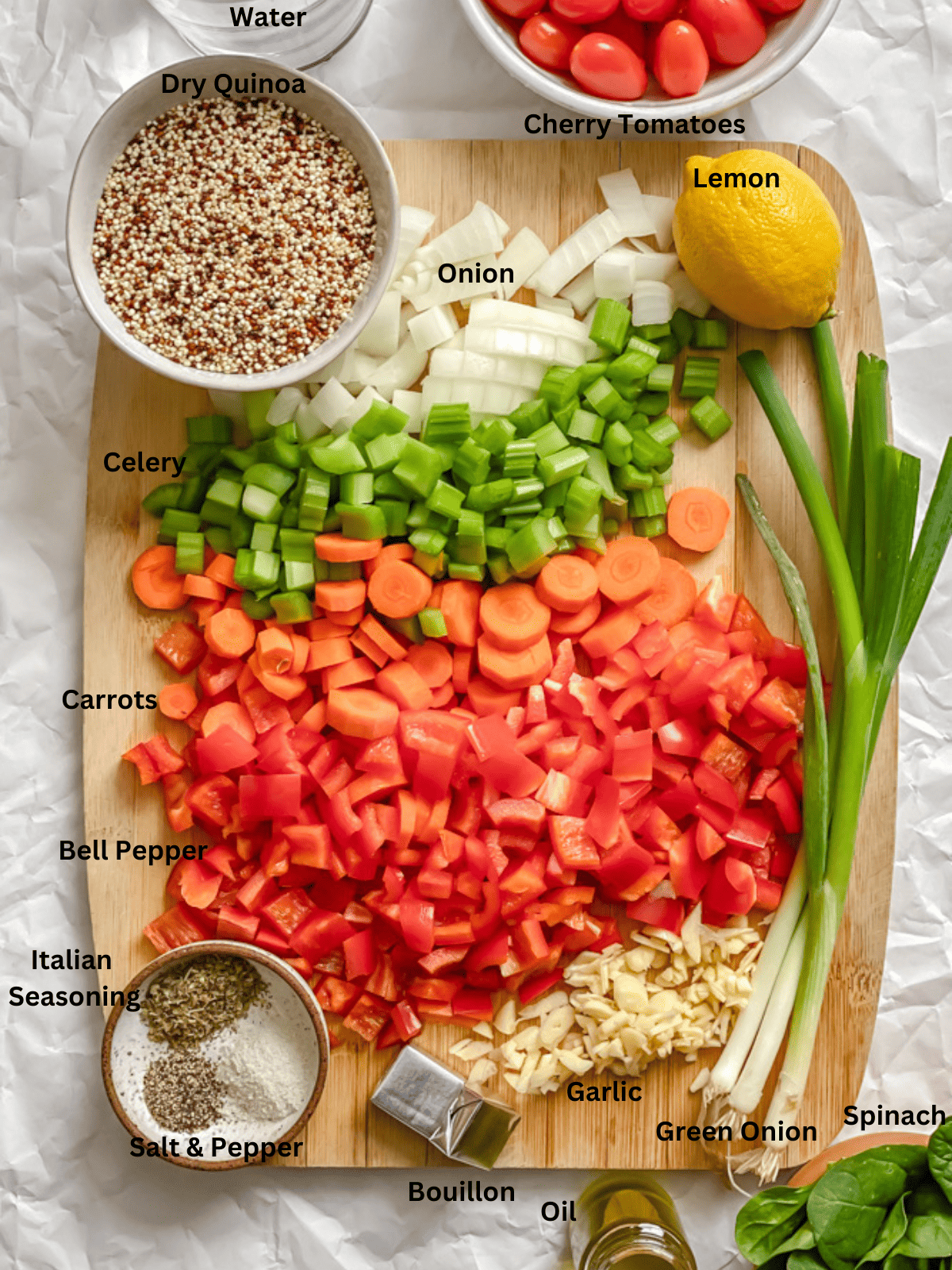 ingredients for Quinoa Vegetable Soup measured out on a white surface
