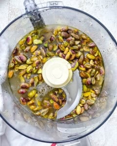 Process shot showing ingredients being added to food processor.
