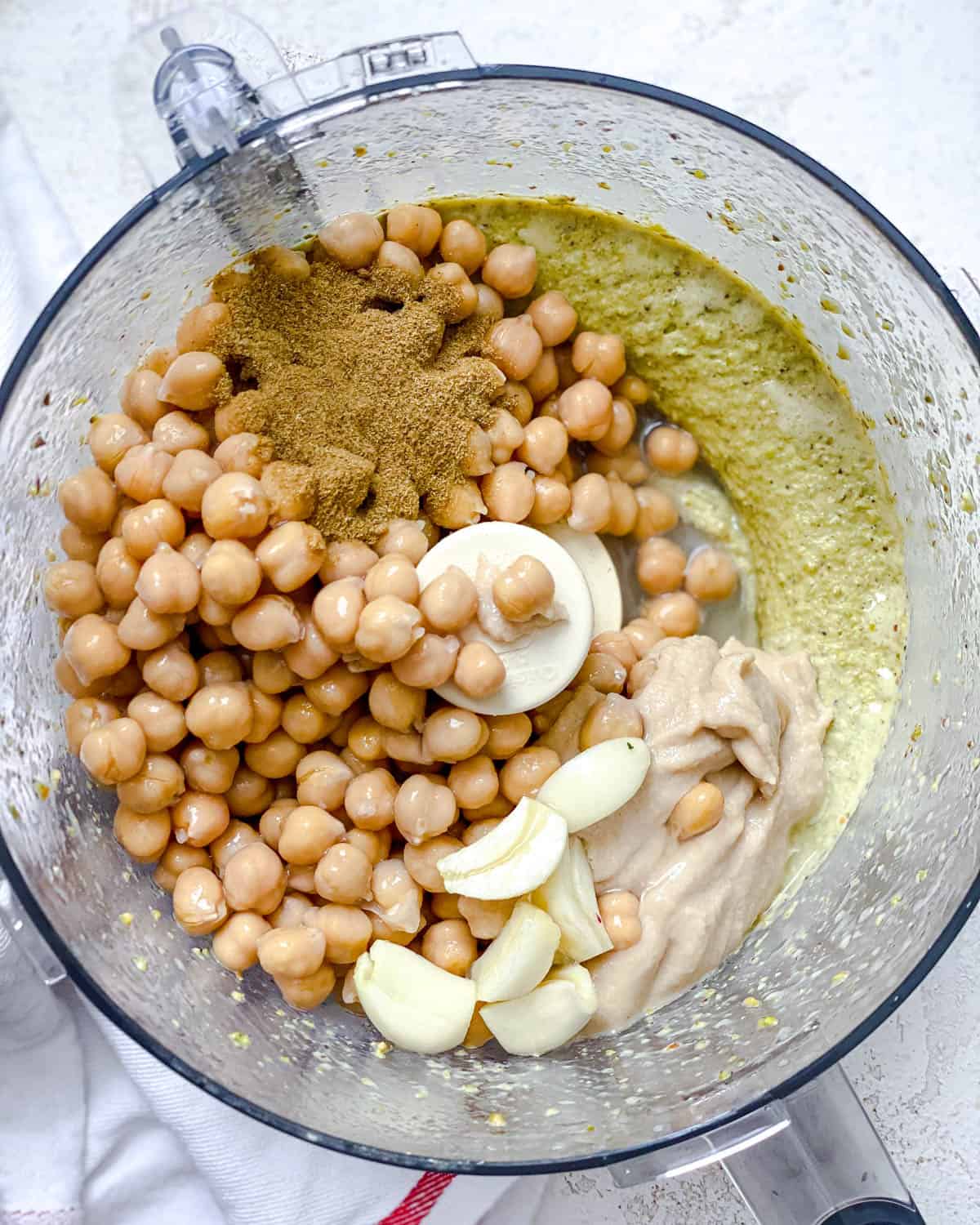 Process shot showing ingredients being added to food processor.