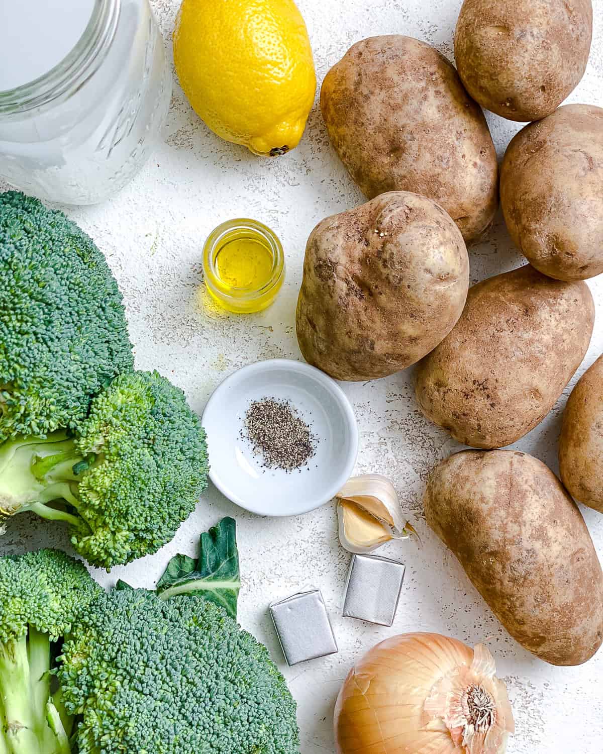 ingredients for Vegan Broccoli Potato Soup measured out on a white surface