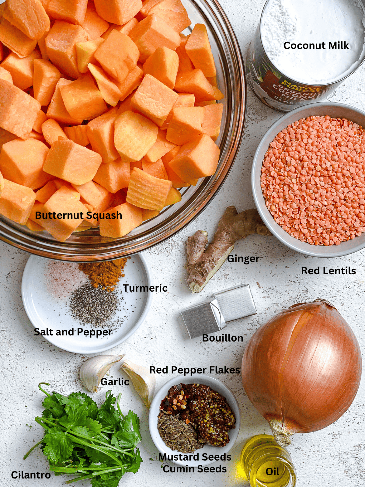 Ingredients for Butternut Squash and Lentil Soup measured out on a white surface.
