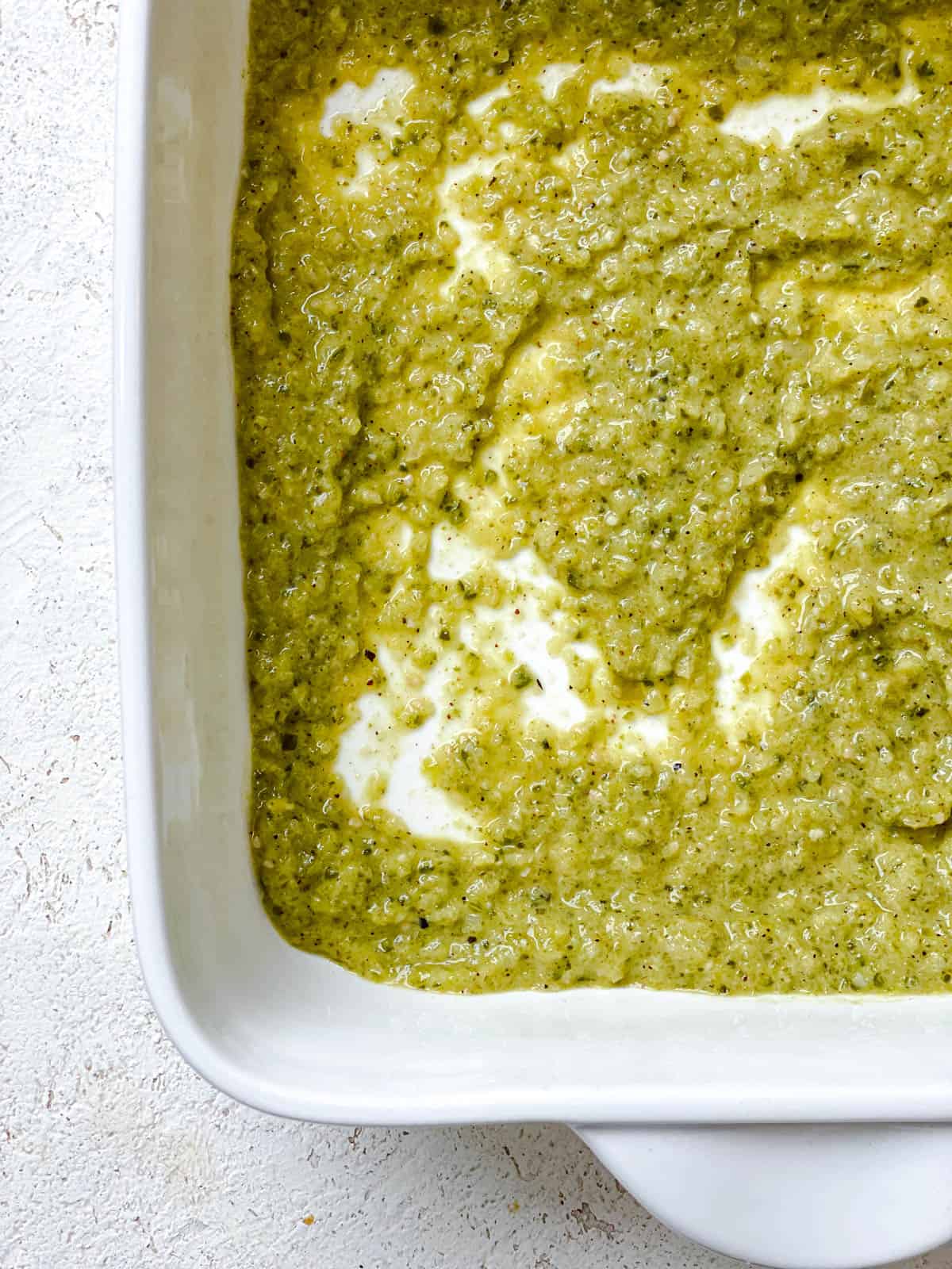 process shot showing salsa verde added to baking dish