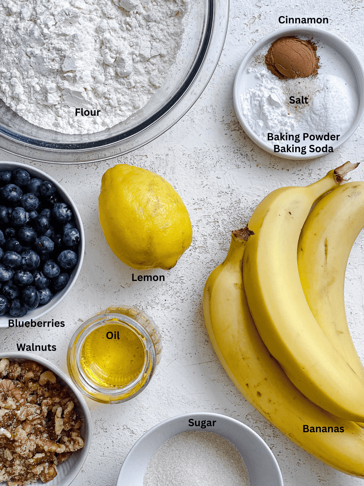 ingredients for Vegan Lemon Blueberry Loaf measured out on a white surface