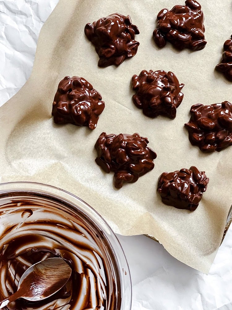 Process shot showing pre frozen peanut clusters on baking sheet.