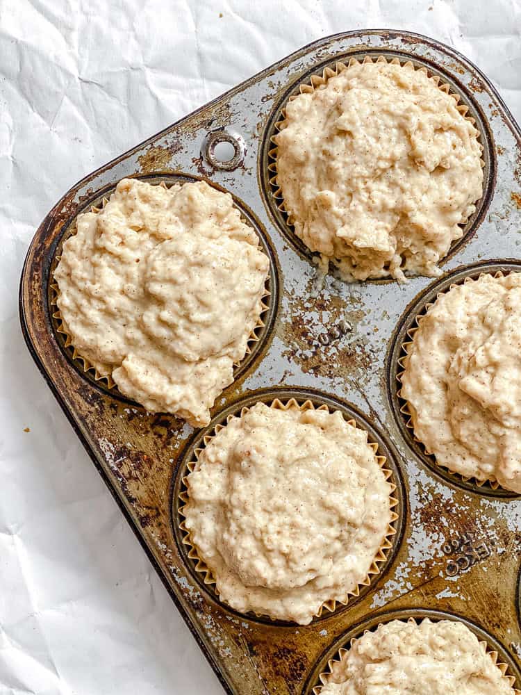 Process shot showing pre-baked muffins in muffin tin.