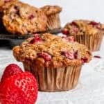 Completed Strawberry Banana Muffins (Egg-Free) against a white surface.