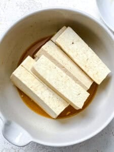 process shot showing tofu in a bowl
