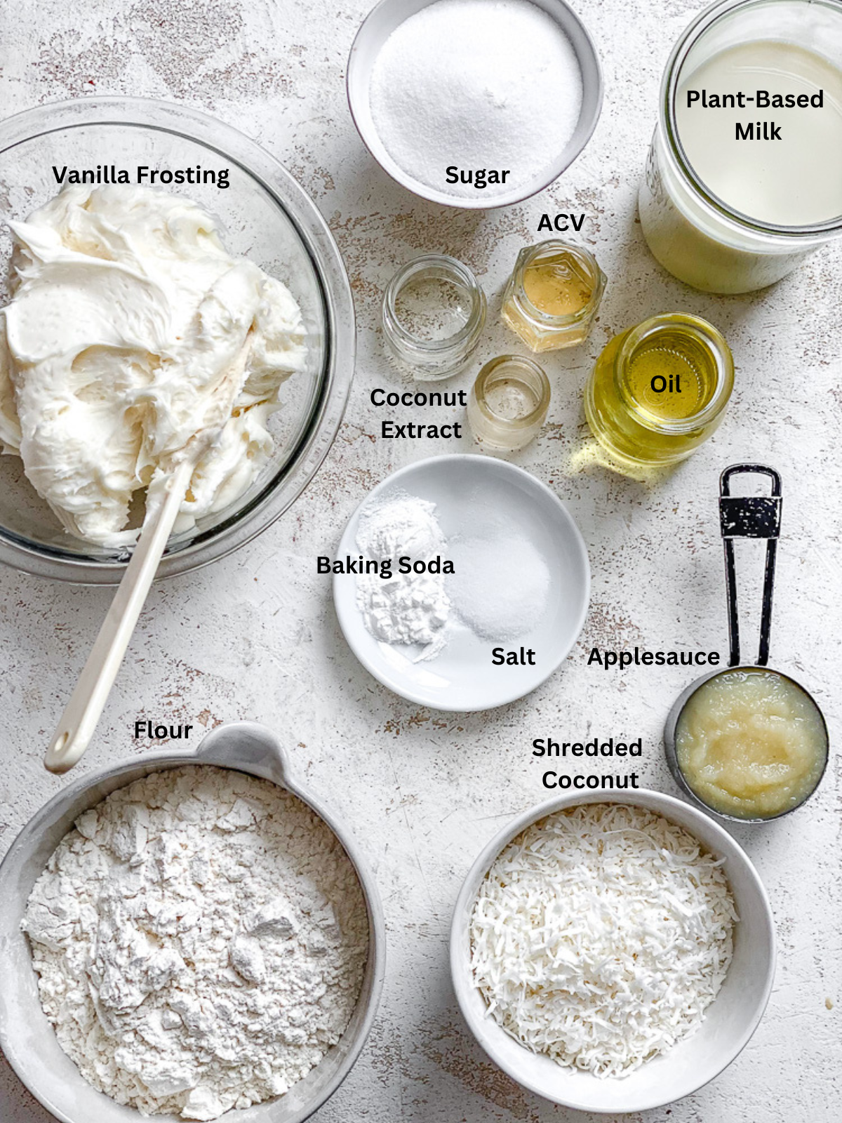 Ingredients for Vegan Coconut Cake measured out on a white surface.