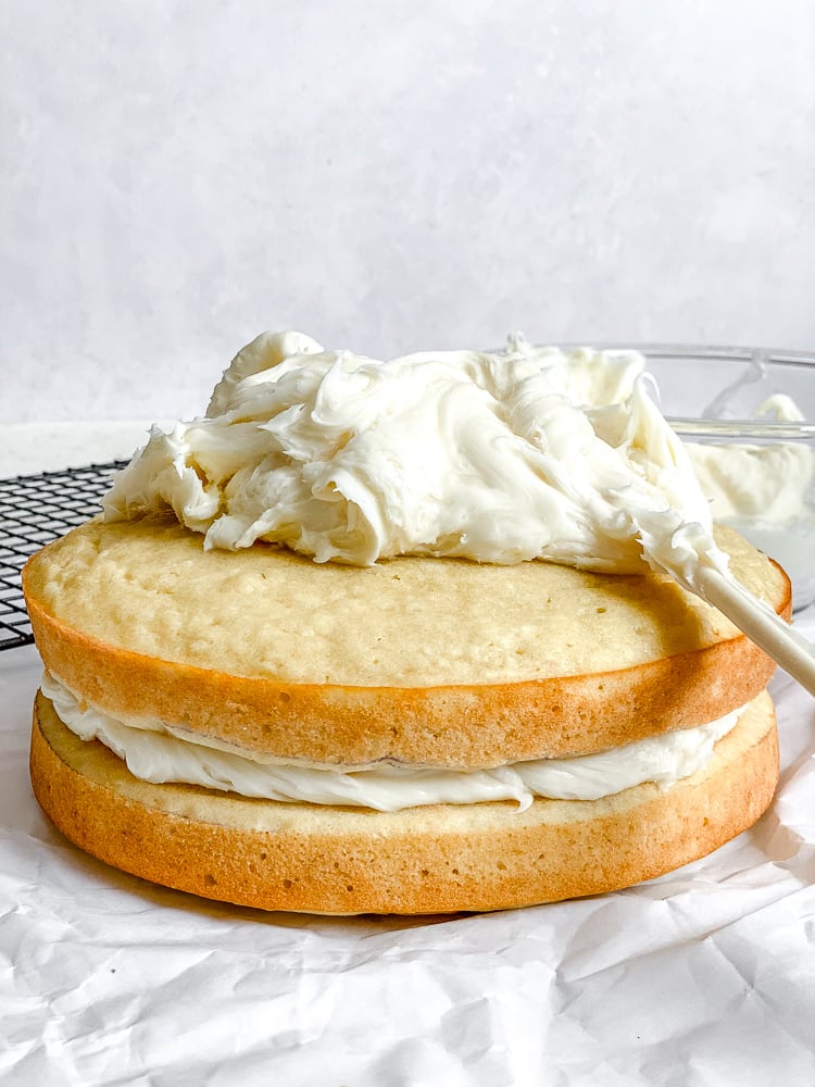 Process shot showing icing the cake.