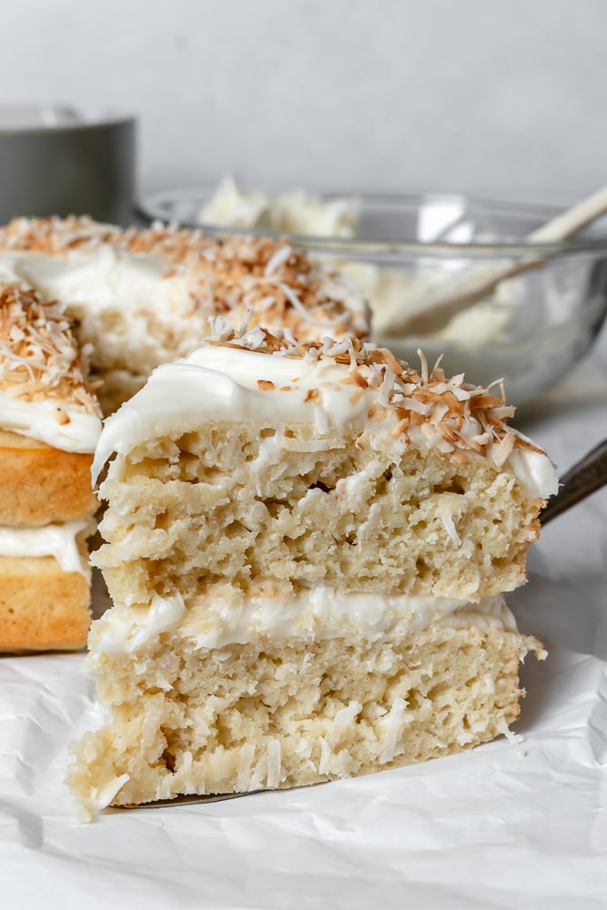 Completed Vegan Coconut Cake on white surface.