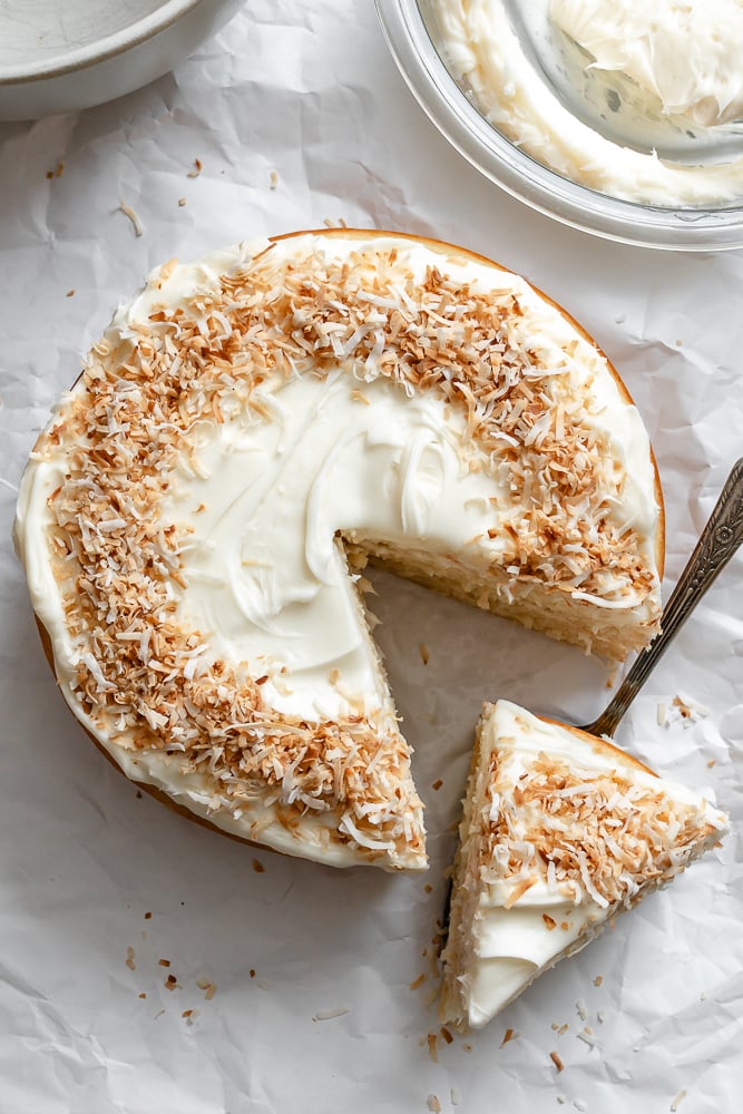 Completed Vegan Coconut Cake on white surface.