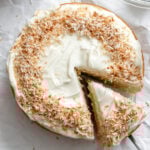 Completed Vegan Coconut Cake on white surface.