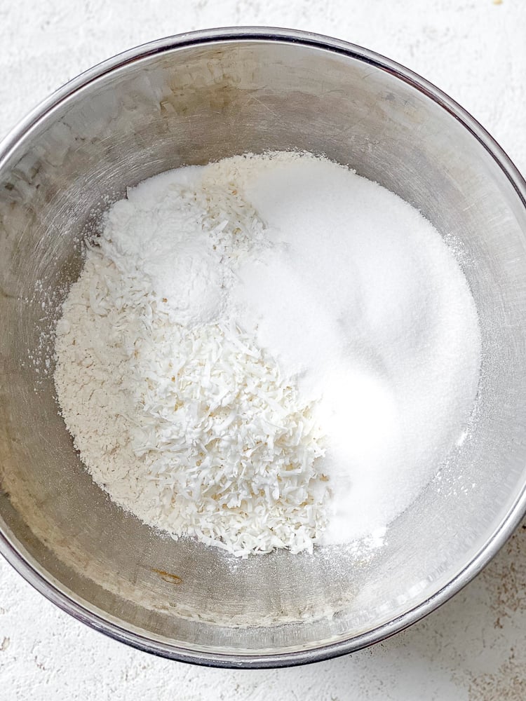 Process shot showing ingredients added to a bowl.