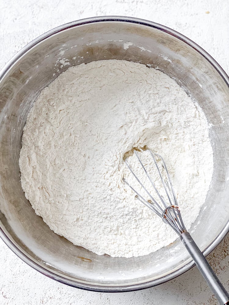 Process shot showing mixing ingredients in a bowl.