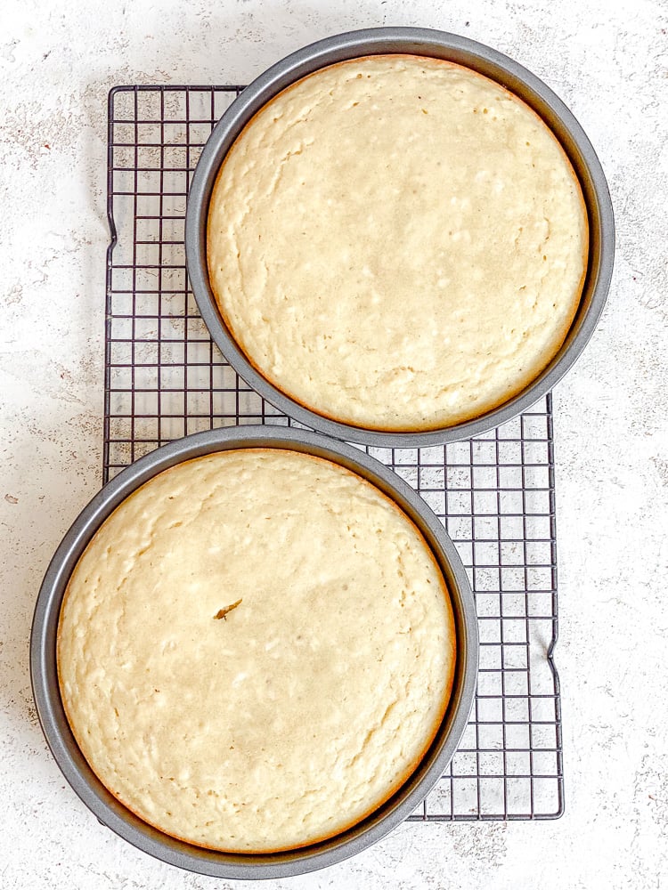 Process shot showing post baked cakes on cooling rack.