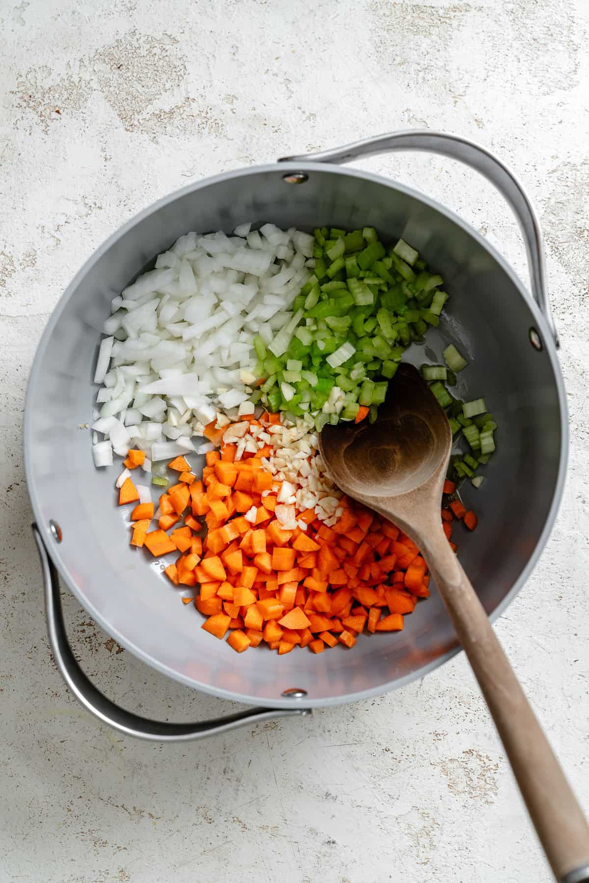 Process shot showing stirring ingredients in a pot.