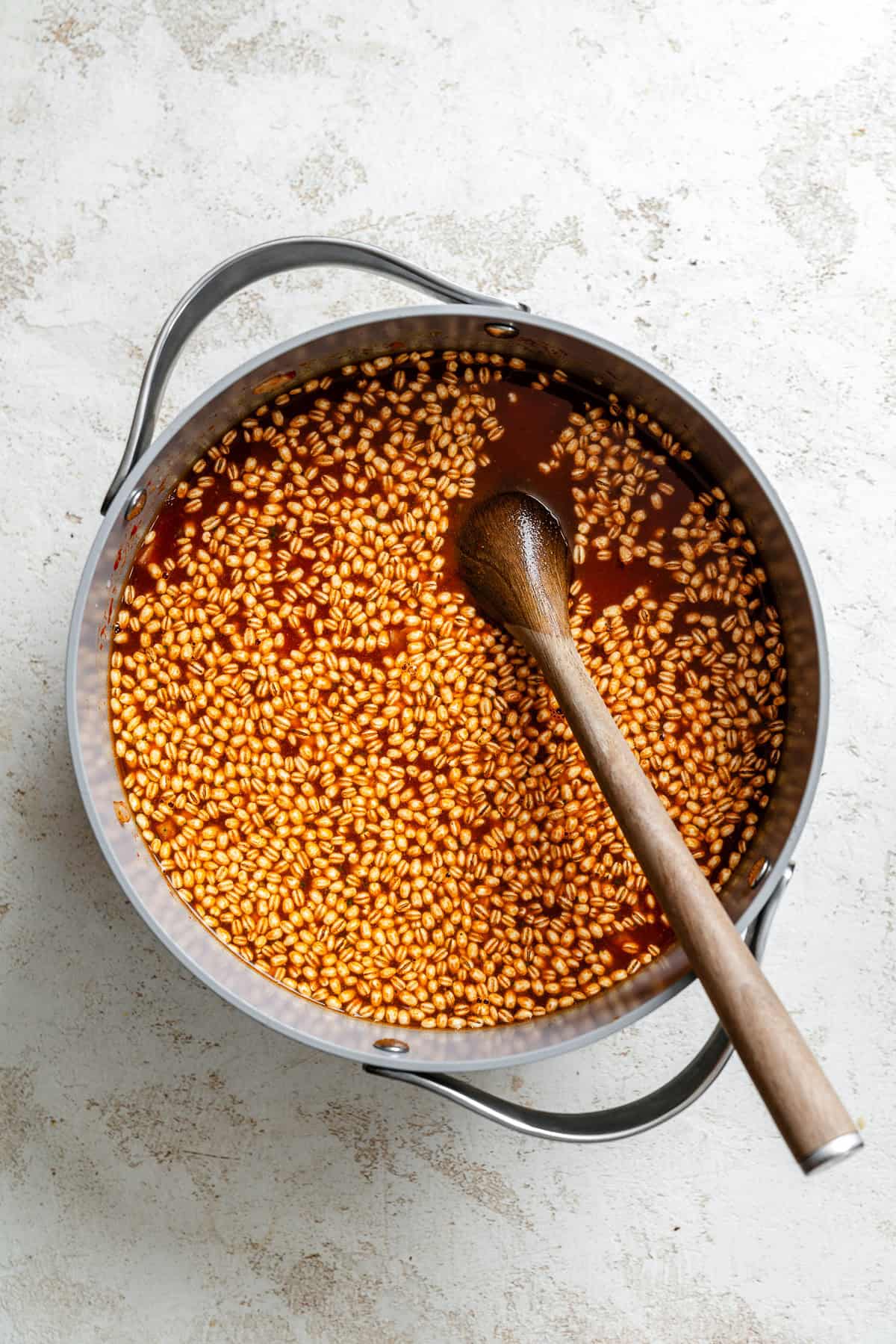 Process shot showing using immersion blender in a pot.