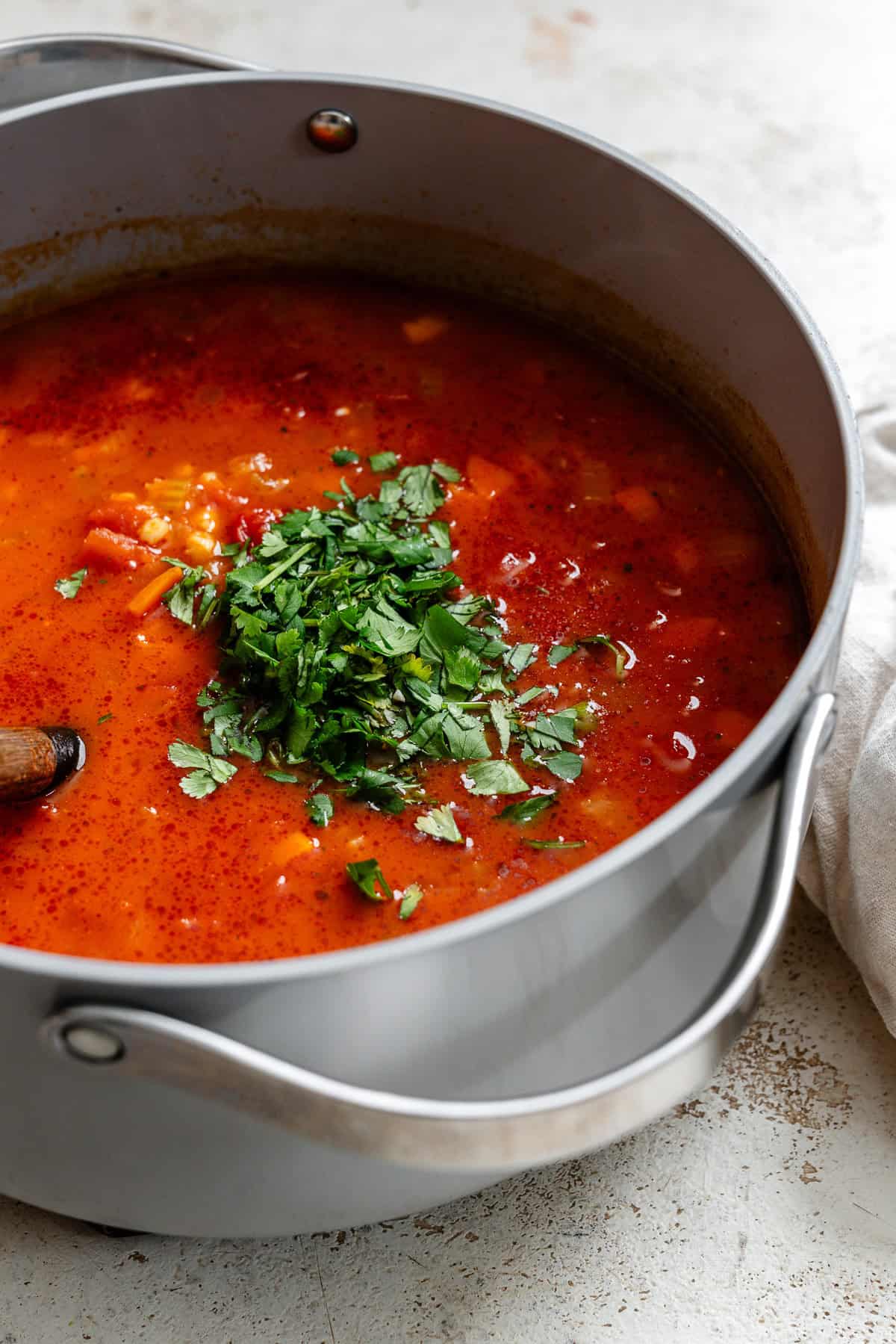 Process shot showing cooking soup in a pot.