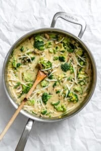 Process shot showing stirring Bean Sprouts Curry in pot.