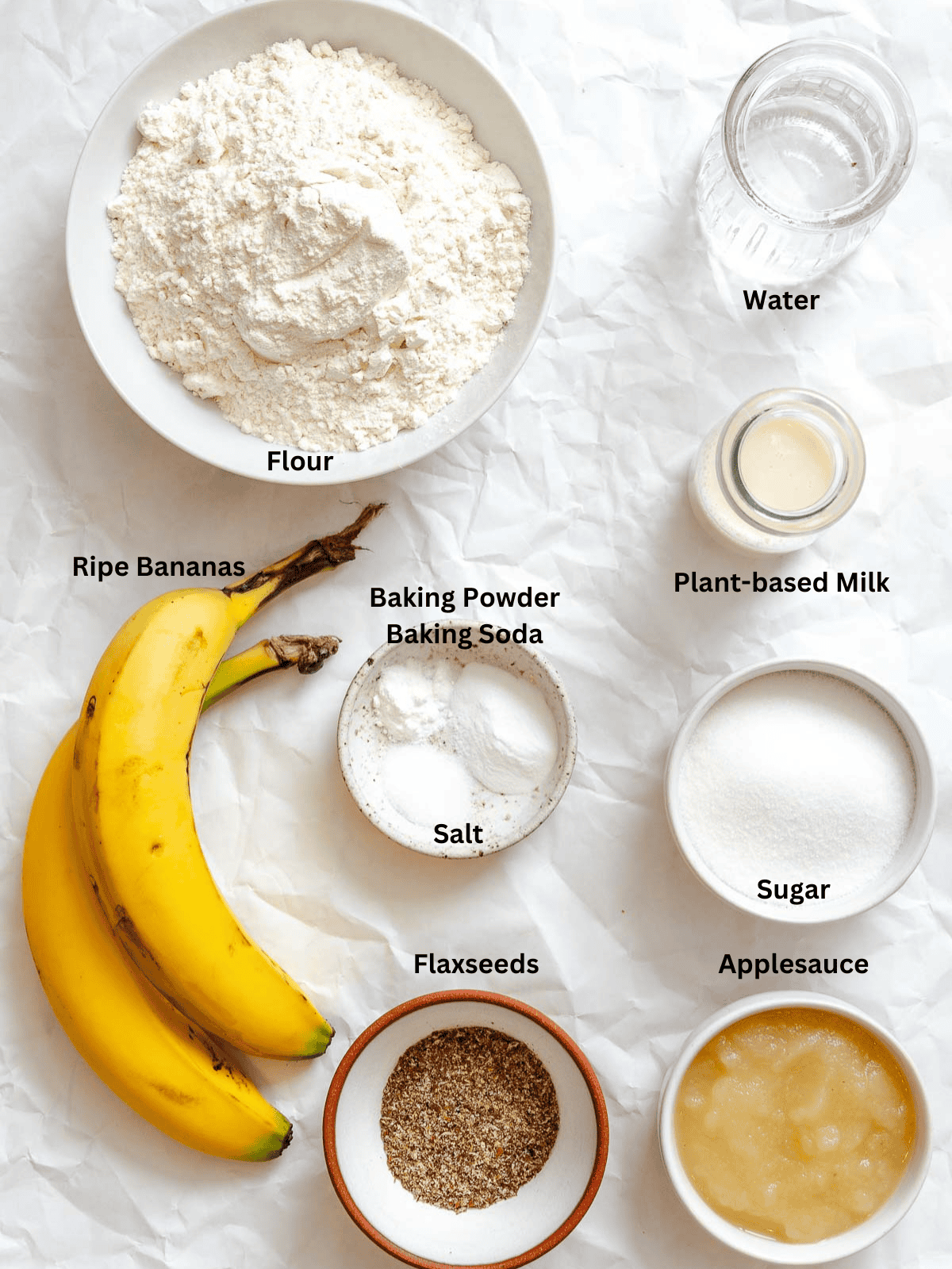 Ingredients for Banana Applesauce Muffins (Oil-Free!) measured out on a white surface.