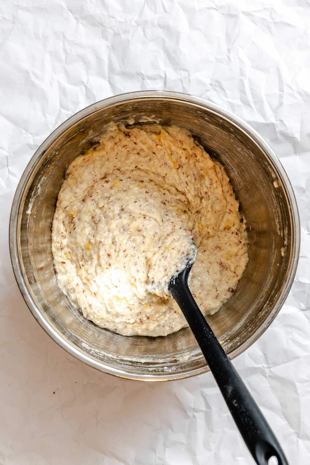 Process shot showing mixing ingredients together in a bowl.