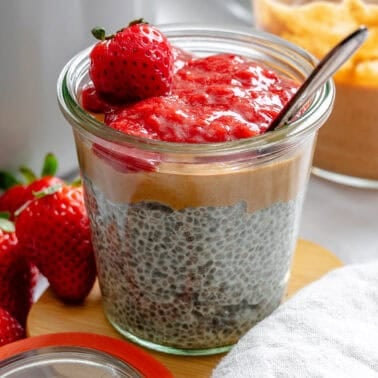 Completed Peanut Butter Chia Pudding [With Berry Compote] in a jar.