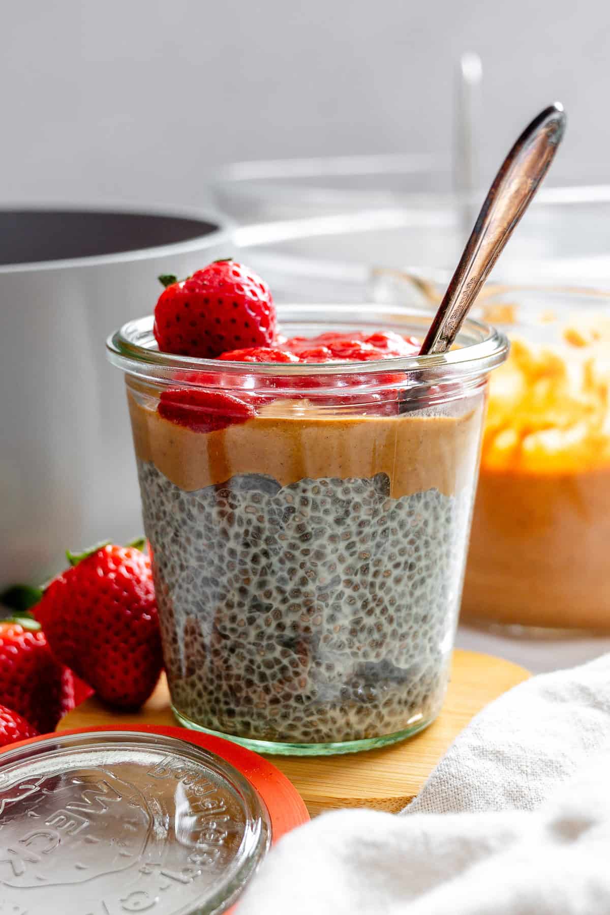 Completed Peanut Butter Chia Pudding [With Berry Compote] in a jar.