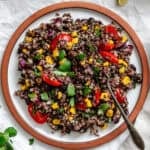 Completed Black Bean Quinoa Salad in a plate on a white surface.
