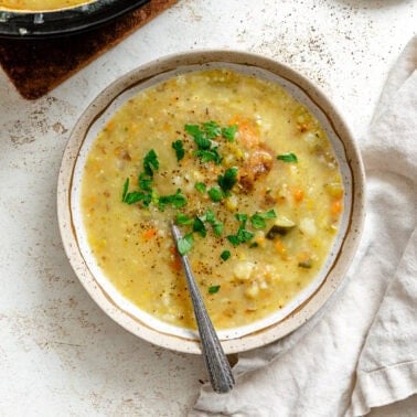 Completed Vegan Potato Soup (with vegetables) in a bowl and pot.