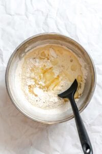 Process shot showing mixing ingredients in a bowl.