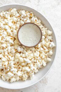 Process shot showing a small bowl inside bowl of popcorn.