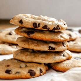 Completed Cinnamon Chocolate Chip Cookies stacked on a white surface.