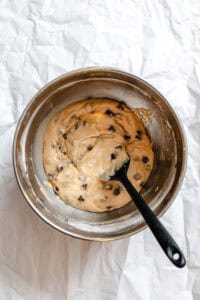 Process shot showing mixing ingredients in a bowl.