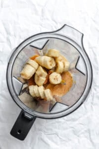 Process shot showing ingredients in a blender.