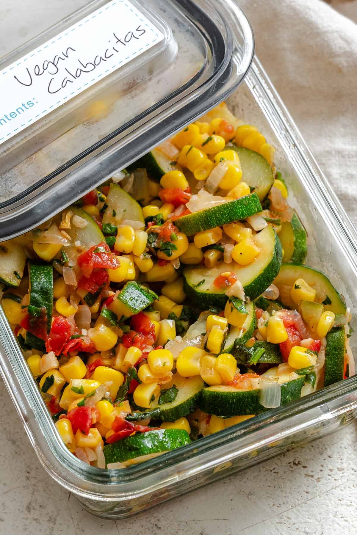 Completed Easy Calabacitas Recipe (Mexican Zucchini) in a storage container.