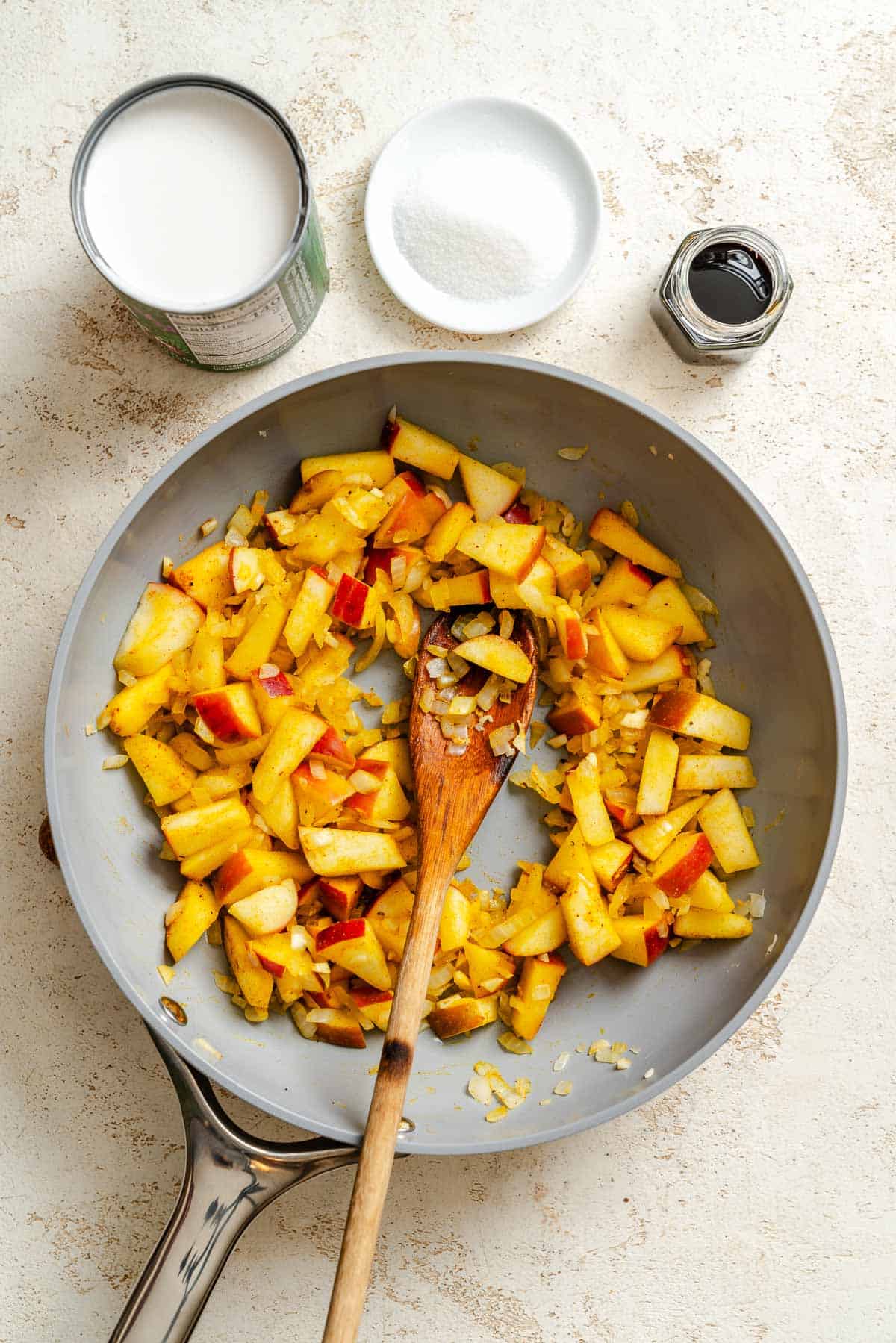 Process shot showing ingredients cooking on pan.