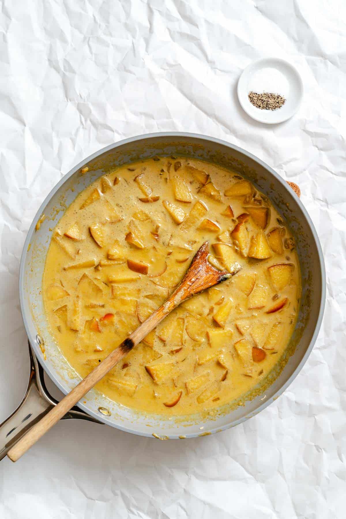 Process shot showing stirring ingredients in pan.