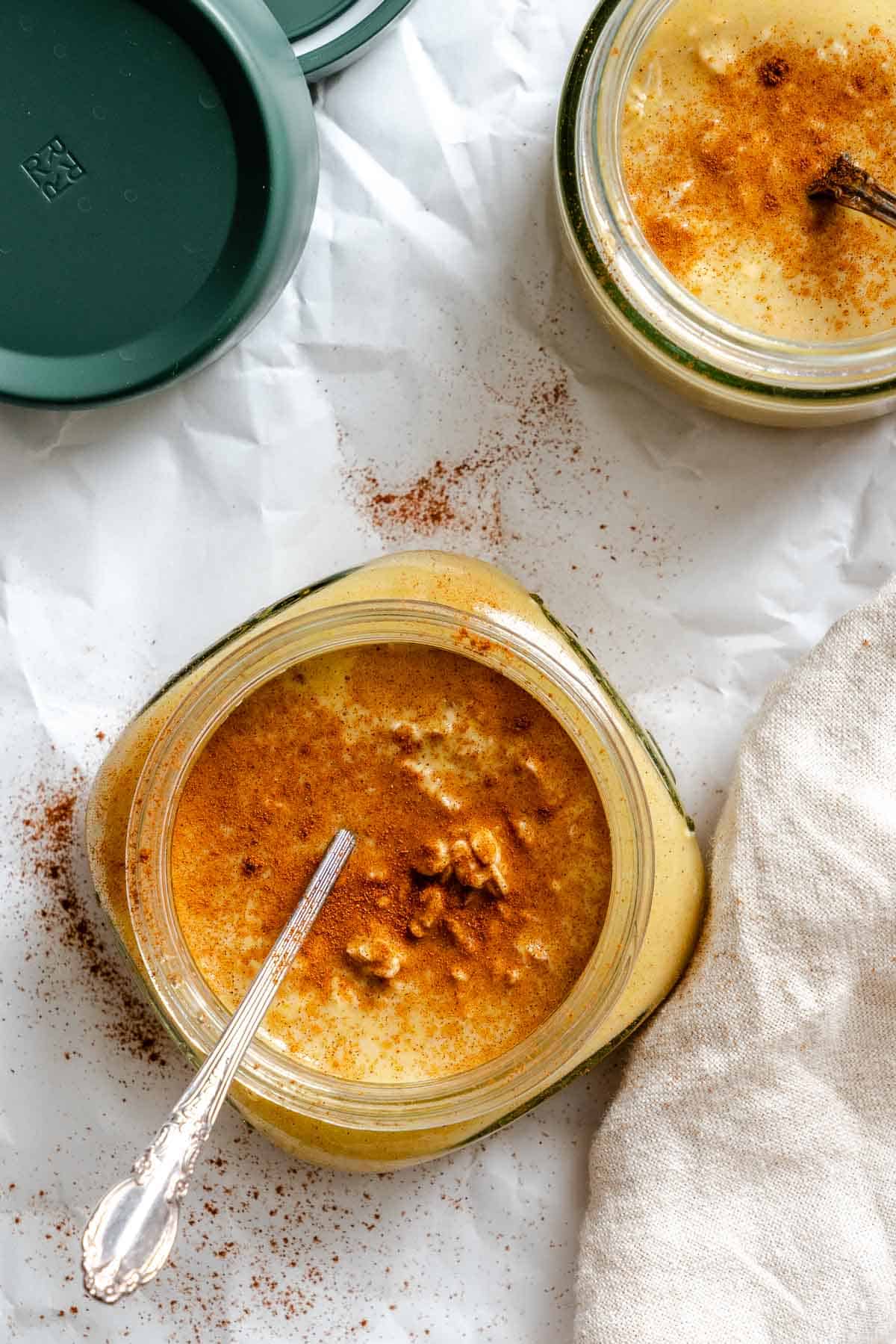 Completed Pumpkin Pie Overnight Oats in storage jar with spoon inside.