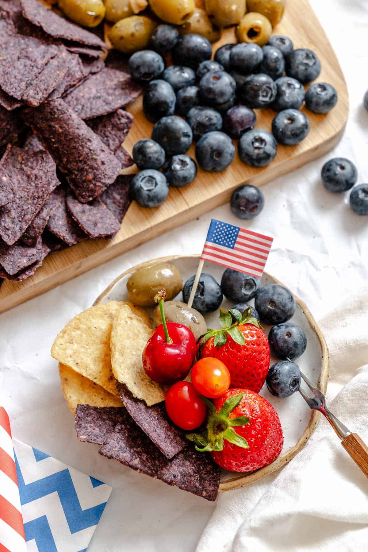 Completed 4th of July Charcuterie Board alongside a small plate.