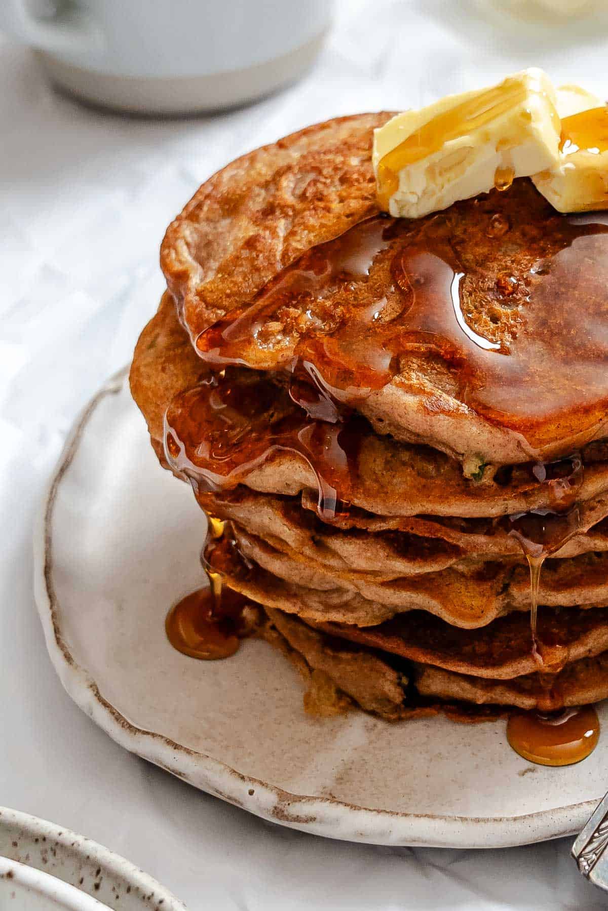 Completed stack of Carrot Cake Pancakes on a plate.