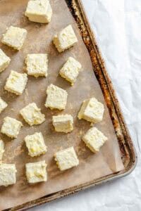 Process shots showing tofu added to baking sheet.