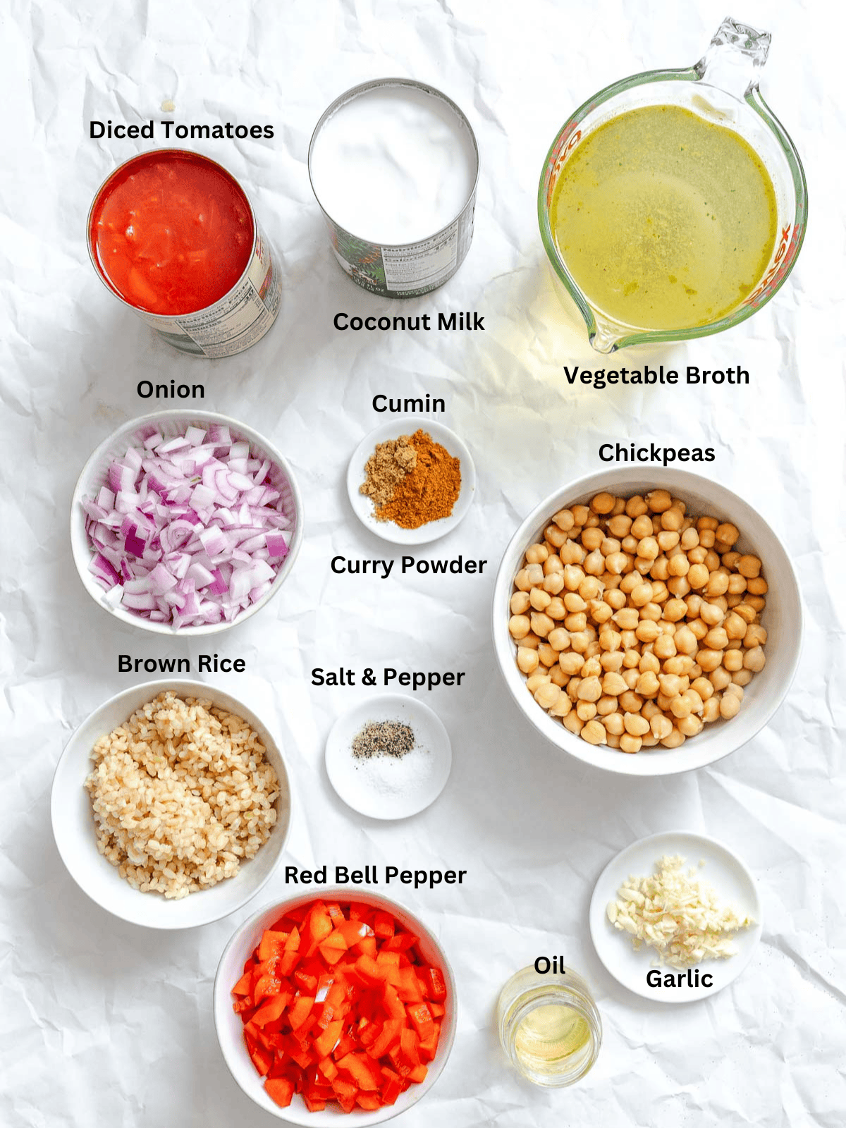 Ingredients for Coconut Chickpea Curry Soup measured out on a white surface.