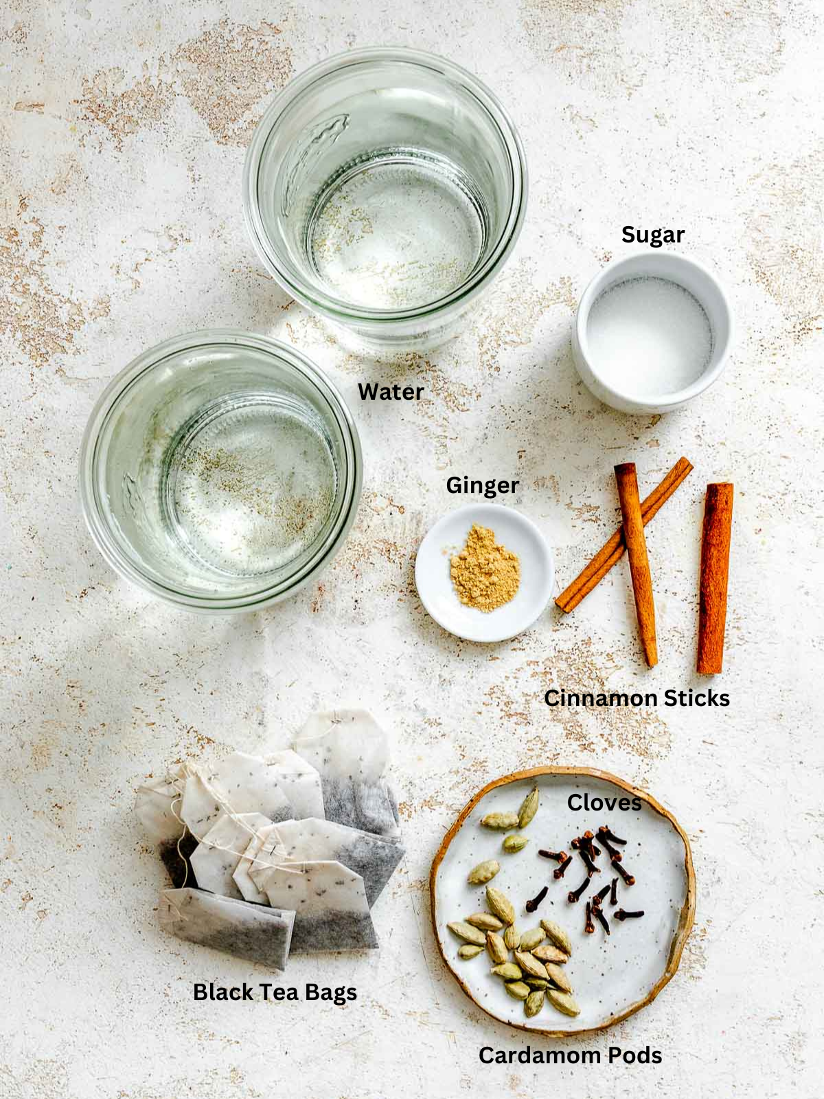 Ingredients for Homemade Chai Concentrate measured out on a white surface.