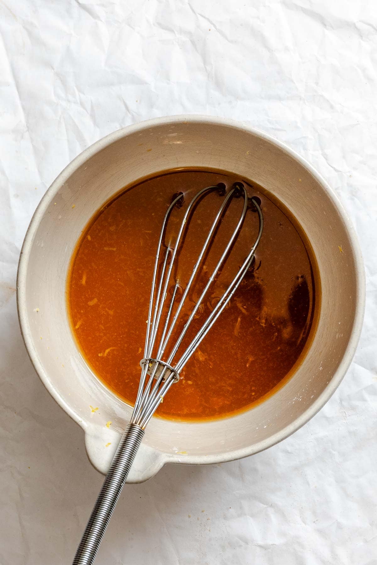 Process shot showing mixing ingredients together in a bowl.