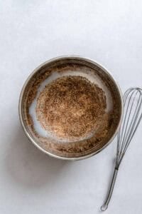 Process shot showing mixing ingredients in a bowl.