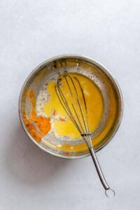 Process shot showing mixing ingredients in a bowl.