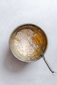 Process shot showing mixing ingredients in a bowl.