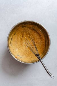 Process shot showing mixing ingredients in a bowl.