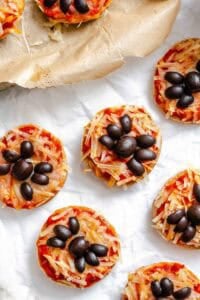 Completed Mini Spider Pizza [Bagel Bites] on a white surface.